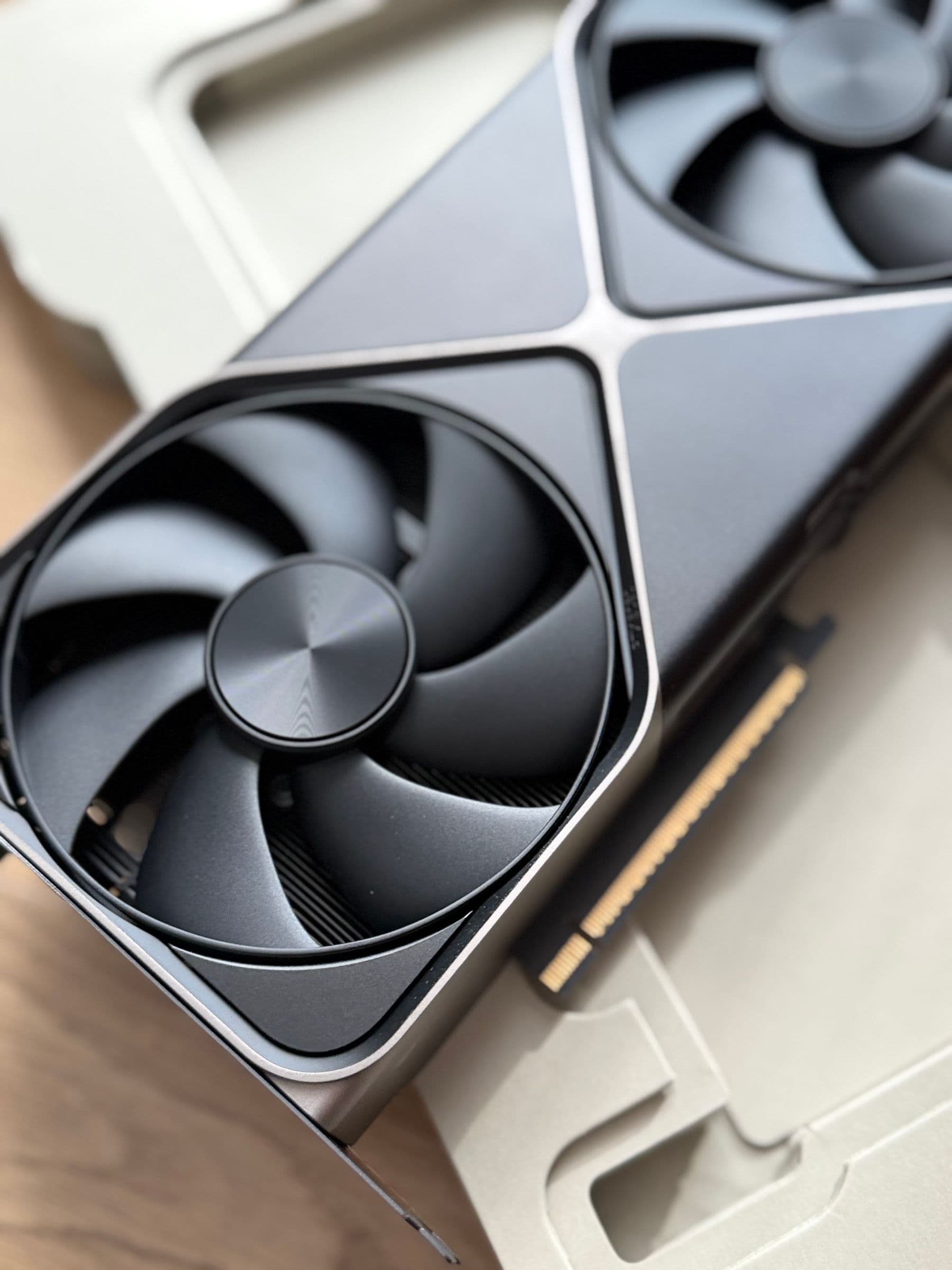 Close-up of the cooling fans on a high-performance graphics card used for AI workloads, no visible brand logo